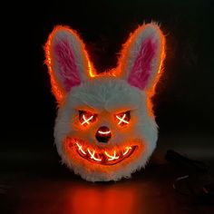 a white bunny mask with glowing eyes and ears