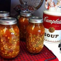 three jars filled with food sitting on top of a counter next to a canister