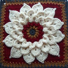 a crocheted square with a flower on it