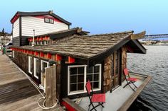 a houseboat is docked at the end of a pier