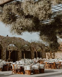 an outdoor dining area with tables and chairs set up for a formal function in the sun