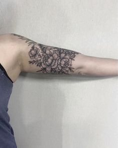 a woman with a flower tattoo on her arm