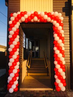 red and white balloon arch with steps leading up to it