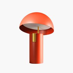 an orange table lamp on a white background