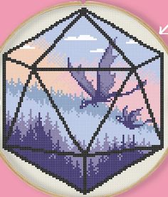 a cross stitch pattern with a bird flying in the sky and mountains on it's side