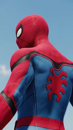 a man in a spider - man suit looks up into the sky with his back to the camera