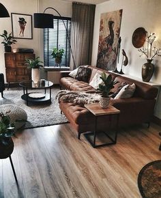 a living room filled with furniture and plants