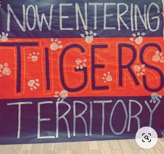 there is a sign that says, now entering tigers territory with paw prints on it