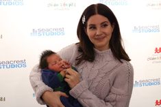 a woman holding a baby in her arms