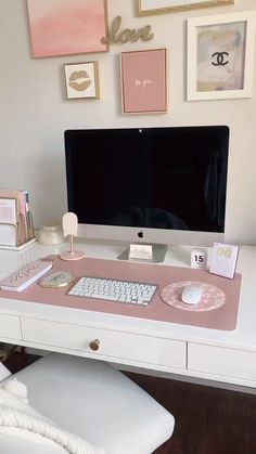 a desk with a computer, keyboard and mouse on it in front of a white chair