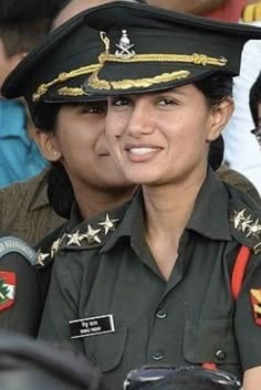 two women in uniform sitting next to each other