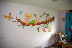 a child's bedroom decorated with fairy tinkerbells and butterflies on the wall