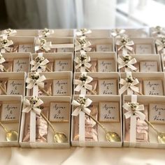 wedding favors in boxes with ribbons and bows on them are ready for the guests to arrive