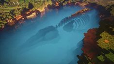 an aerial view of a lake surrounded by mountains and trees in minecraft, with blue water