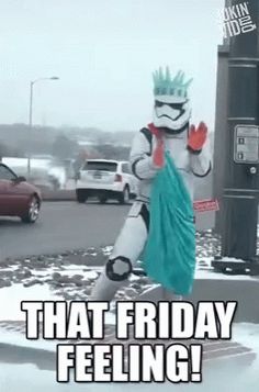 a person dressed up as storm trooper walking in the snow with text that friday feeling