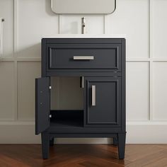 a bathroom vanity with a mirror above it and a sink in front of the cabinet