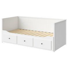 a white bed with drawers underneath it