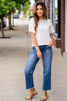 Never underestimate the power of a basic tee! This features a more cropped length making it ideal for all of your high-waisted shorts, pants, skirts, and jeans! Wear this as is or use as a base for all of your layering pieces! 100% Cotton High-waisted Cotton Tops For Day Out, High Waist Cotton Tops For Day Out, Everyday Cropped Summer Bottoms, Casual Cropped Hem Bottoms For Summer, Casual Denim Bottoms With Cropped Hem, Casual Stretch Medium Wash Crop Top, Medium Wash High Waist Top For Day Out, Casual Cotton Crop Top With Pockets, Stretch Cotton Cropped Bottoms