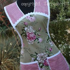 a woman's apron with pink flowers on it