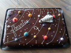 a chocolate cake with planets on it