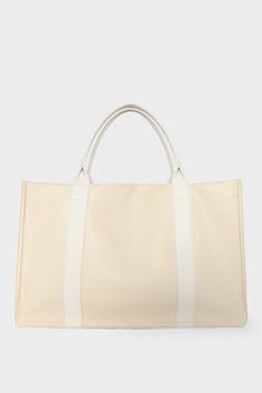 A large white tote bag with a rectangular body. It has a wide top with a magnetic closure. The bag has 2 handles to be carried handheld or as a shoulder bag. Elegant Large White Bag, Top Handle Weekender Bag For Shopping, Classic Shopping Bag With Double Handle, Classic Double Handle Bags For Shopping, Classic Double Handle Shopping Bags, Chic Weekender Bag With Double Handle, Luxury Tote Weekender Bag For Shopping, Luxury Weekender Tote Bag For Shopping, Classic Beige Weekender Bag With Double Handle