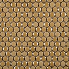 the back side of a wall with circles on it in gold and brown colors,