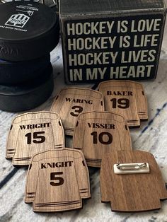 hockey themed wooden coasters are sitting on the floor next to an ice pucker