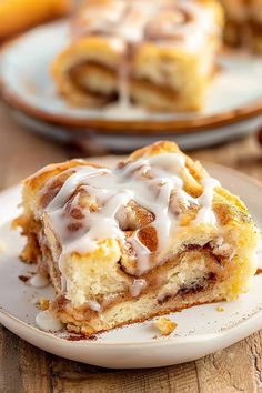 cinnamon roll on a plate with icing drizzled over it's top