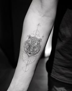 a black and white photo of a tiger's head on the left arm with geometric shapes