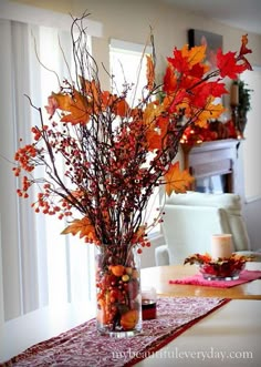 a vase filled with lots of flowers on top of a table next to a window