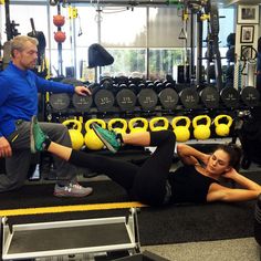 a man and woman doing exercises in a gym