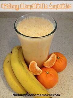 there are oranges and bananas next to a smoothie