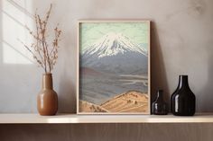 two vases are sitting on a shelf with a painting in front of the mountain