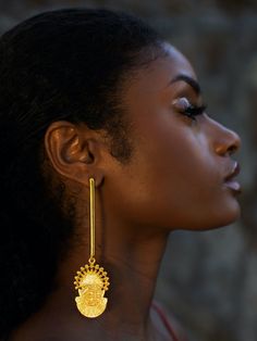 Toronto-based Symbols of Authority specializes in everyday statement jewelry. Inspired by the 16th-century Bini Queen Idia, renowned for her bravery, the Adunni x Idia Bar Earrings boast a shoulder-sweeping bar design. They are handmade from micron-plated brass and etched with the iconic Iyoba ivory mask. Make them the focal point by keeping your other jewelry pieces simple.- Butterfly fastening- Brass, micron-plated gold- Handcrafted by expert artisans using ethically and sustainably sourced materials- Made in Jaipur, India, ships from Canada Ceremonial Drop Earrings, Temple Jewelry Style Drop Plug Earrings, Hand Forged Gold Earrings, Gold Fusion Long Drop Earrings, Yellow Gold Spiritual Earrings, Spiritual Yellow Gold-plated Earrings, Spiritual Yellow Gold Plated Earrings, Spiritual Hand Forged Dangle Earrings, Spiritual Hand-forged Dangle Earrings