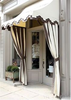 an image of a storefront with curtains on it