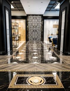 an elegant lobby with marble floors and black walls