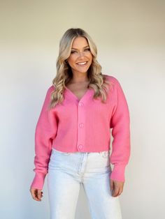 Indulge in the effortlessly chic Bubblegum Cardigan, crafted with a refined v-neckline and luxurious knit fabric for a perfect balance of style and comfort. Button closures provide a secure fit, ensuring you are snuggled up in absolute coziness. Its sophisticated yet vibrant aesthetic is sure to make a bold statement at the office or for a brunch date. Boasting a relaxed fit, ribbed hemline and trend-setting hue, the Bubblegum Cardigan effortlessly transitions you from fall to winter. 100% Polye Chic V-neck Textured Knit Cardigan, Chic V-neck Sweater With Button Closure For Winter, Knit V-neck Cardigan With Buttons, Elegant Pink V-neck Cardigan, V-neck Soft Knit Cardigan, Soft Knit V-neck Cardigan, Chic V-neck Knit Cardigan, Trendy V-neck Cardigan For Layering, Knit V-neck Cardigan With Button Closure