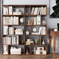 a bookshelf filled with lots of books on top of a hard wood floor