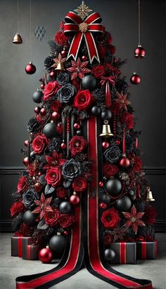 a christmas tree decorated with red and black ornaments, bells and bows is shown in this image