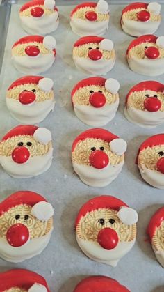 some cupcakes are decorated like santa claus