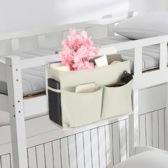 there is a white bunk bed with two drawers on the bottom and a pink flower in it