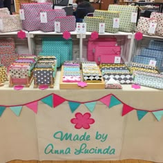 the table has many boxes on it and is decorated with pink, green, blue, and white polka dots