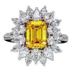 Inspired by the Victorian era, this hand crafted floral ring is graced with timeless glamour. Showcasing a dazzling 2.01 Emerald Cut Fancy Vivid Yellow Diamond / VS2 and accented by 2.29 Carat of 20 E-F/ VVS mixed shaped diamonds. The one-of-a-kind ring is totaling 4.30 Carats which are mounted on 18K white gold. Ring is size 6 and can be resized. Jewel Details: Center Diamond- GIA certified 2.01 Emerald Cut Fancy Vivid Yellow Diamond, VS2 Side Diamonds- 20 Mixed shaped diamonds, E-F / VVS 18K w Yellow Diamond Ring, Canary Diamond, Timeless Glamour, Dream Party, Yellow Diamonds, Yellow Diamond Rings, Diamond Jewelry Designs, Floral Ring, Yellow Sapphire