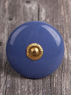 a blue door knob on a wooden surface