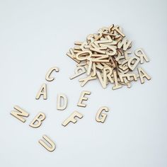 wooden letters and numbers are scattered on a white surface