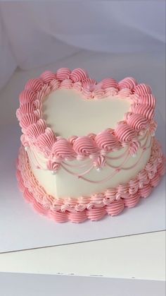 a heart shaped cake sitting on top of a table