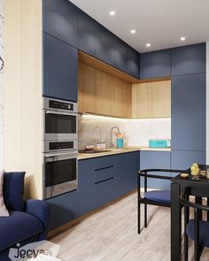 a modern kitchen with blue cabinets and wood flooring, along with a dining table