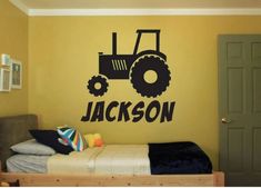 a child's bedroom with a tractor decal on the wall