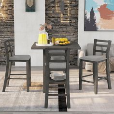 a kitchen table with two chairs next to it and a plate of fruit on the table