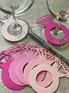 some wine glasses and paper cutouts on a table